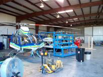 Helicopter being repaired inside hangar