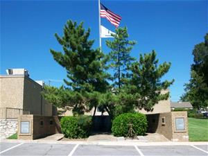 trees and american flag at veterans memorial